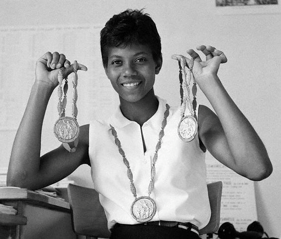 Wilma Rudolph holding her Olympic medals.