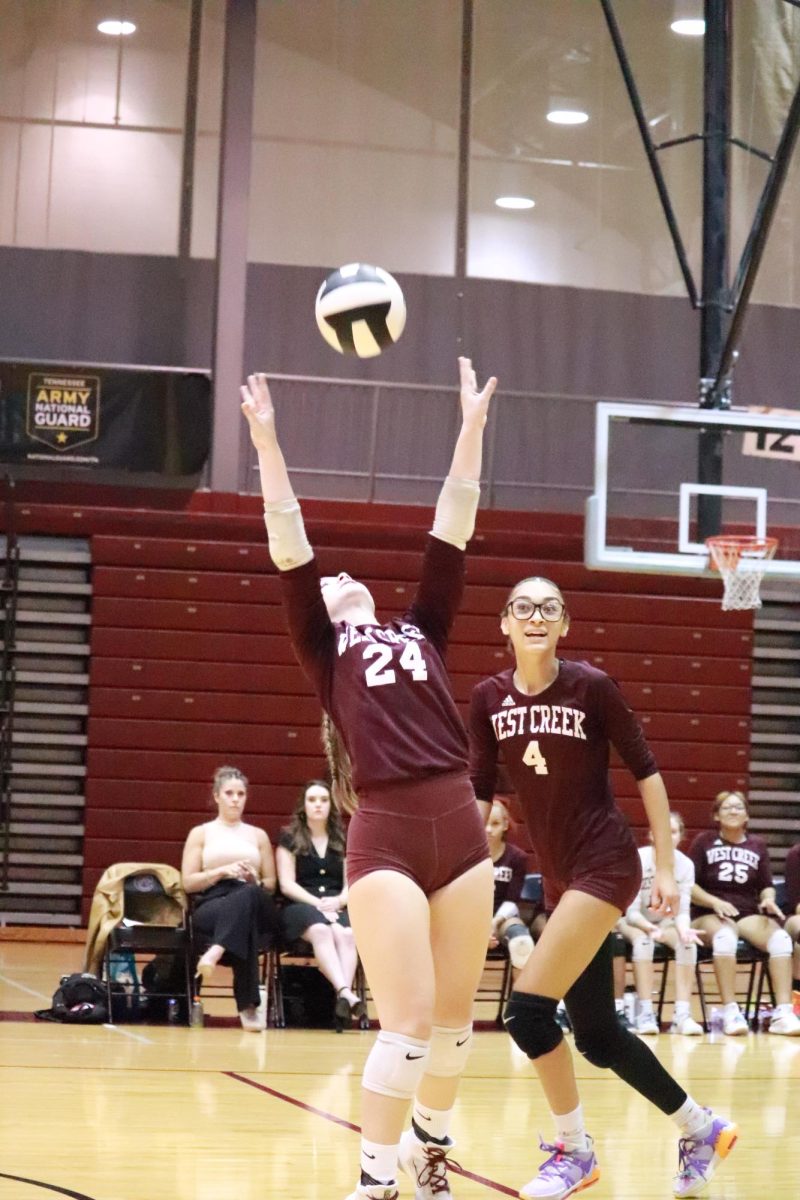 Senior Elysse Holloway (24) sets the ball for her teammate Shawna Graham (4) during a match on Sept. 28, 2023.