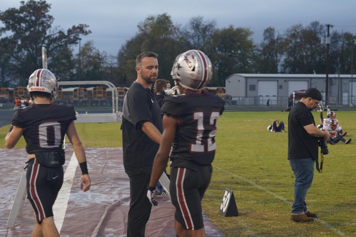 Head coach Rob Gallowitz shakes hands with senior Jayden Hines during Senior Night against the Kirkwood Cobras. The Coyotes won the game 24-21, clinching the schools second playoff appearance.
