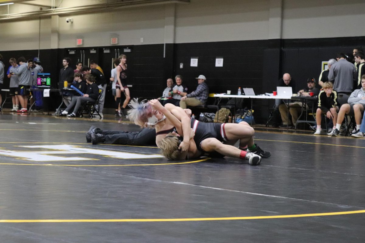 Caleb Villaluz, 11, grapples with his opponent at Hendersonville High School.
