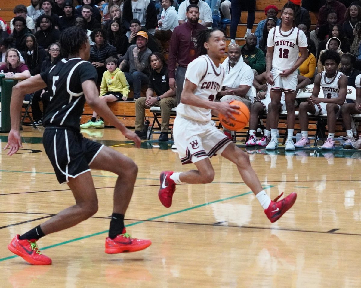 Kameron Bowers drives for a layup in the district championship game against Kenwood on March 7, 2024.