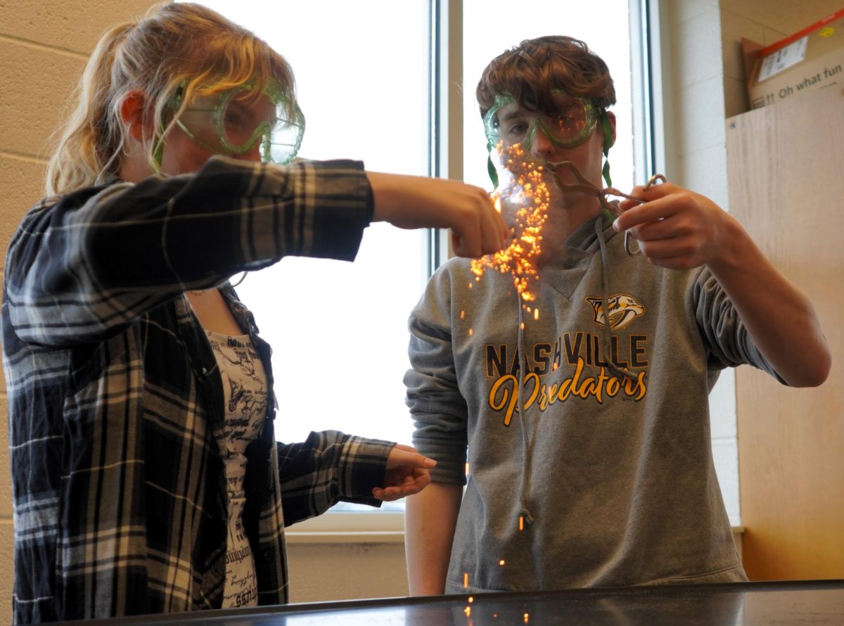 In Mr. Kurt Wright's chemistry class, Brianna Kessler and Colin Bailey burn a piece of steel wool during an experiment.