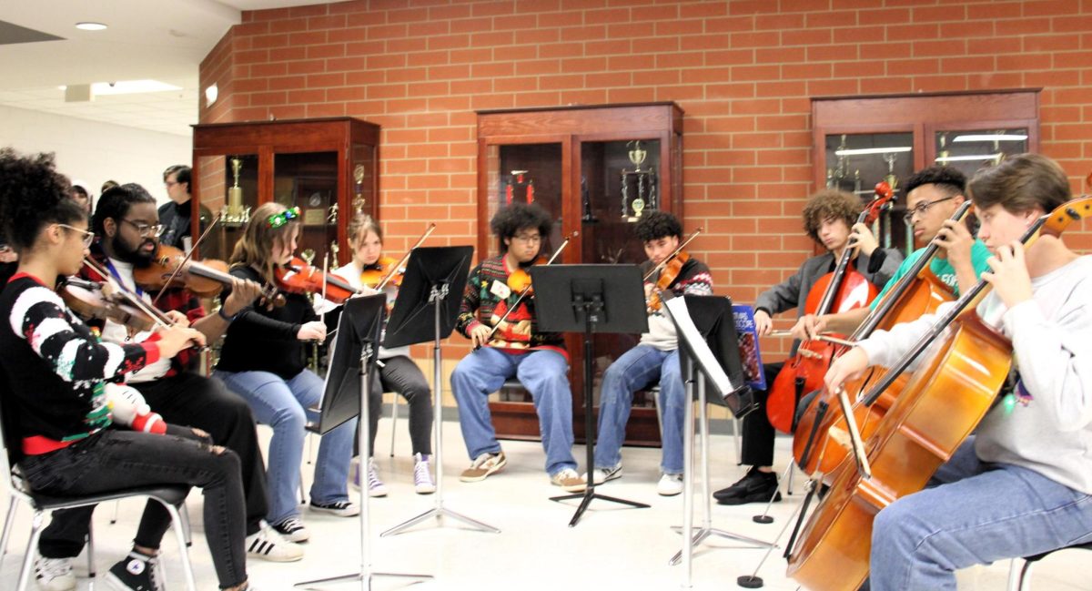 The strings section plays at Christmas at the Creek on December 5, 2023.