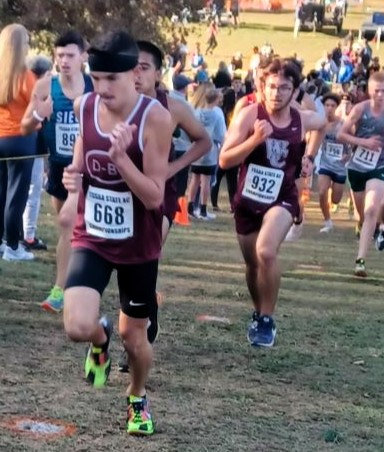 Evan Sims, 11, (#932) pushes uphill during a meet this season.