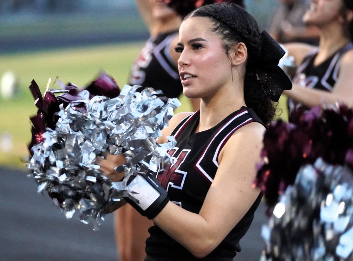 Senior cheerleader Aeriona Cockran cheers during a football game.