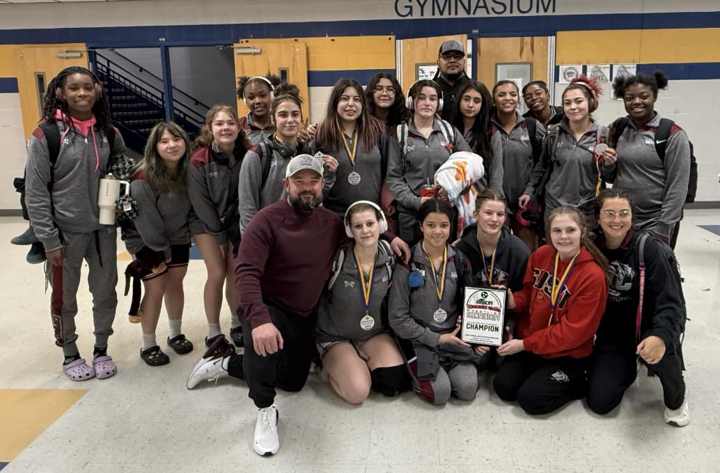 The girls wrestling squad shows off their hardware after winning the Middle Tennessee Wrestling Officials Association Championship on Saturday, Jan. 18.